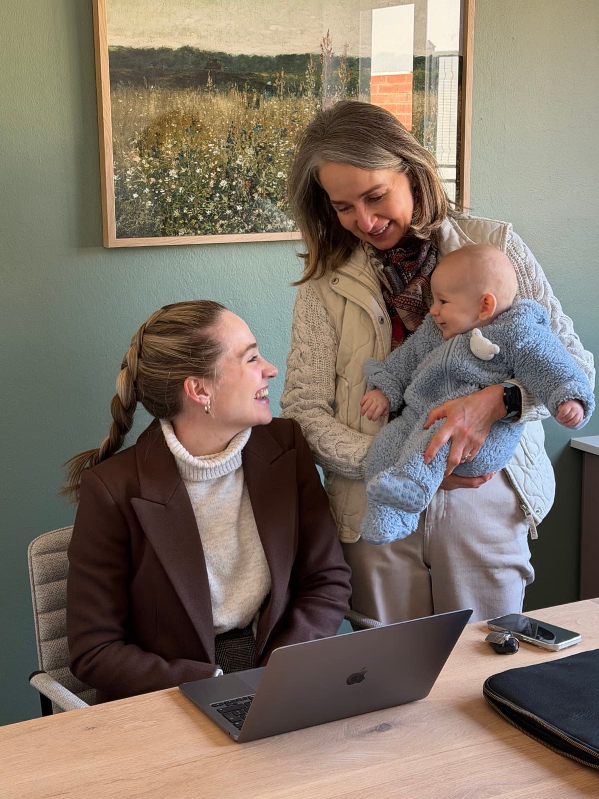 Dr. Madri Verster in consultation with a mother and her baby
